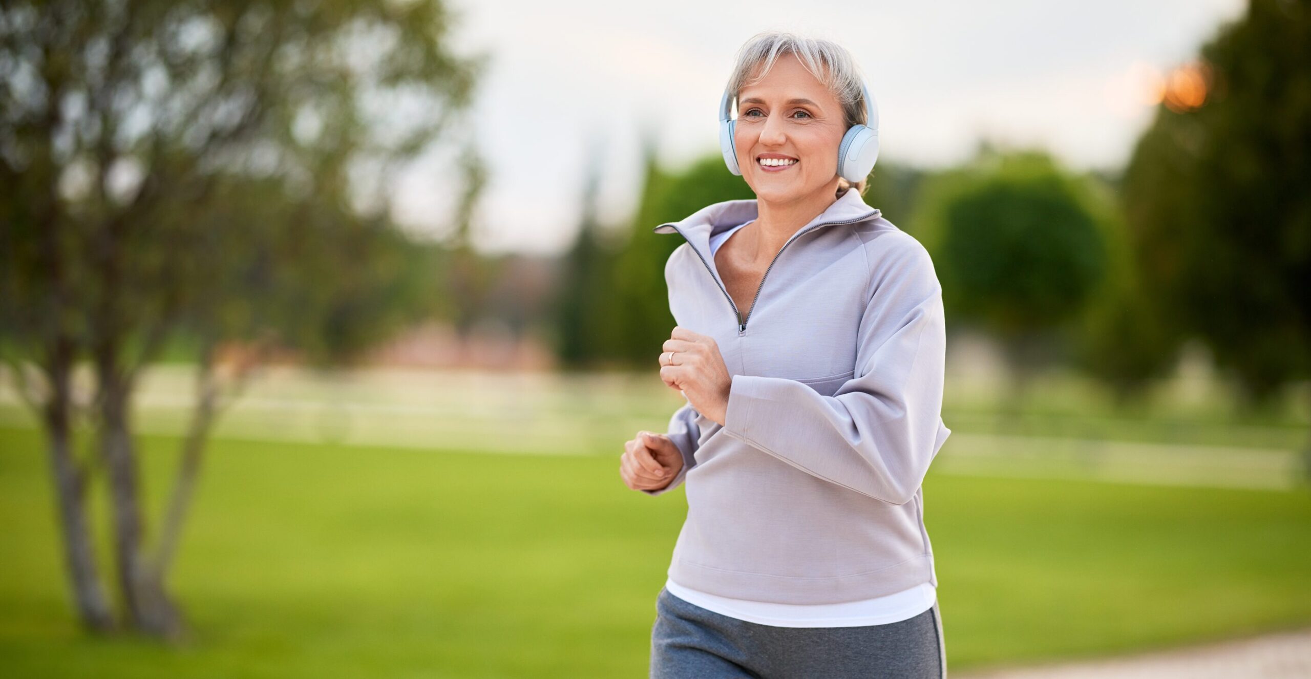 Woman walking in the park, enjoying a healthy lifestyle.